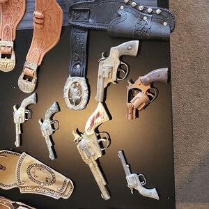 6 Toy Cap Guns, 3 holster belts, & 3 add to your own belt type holsters.